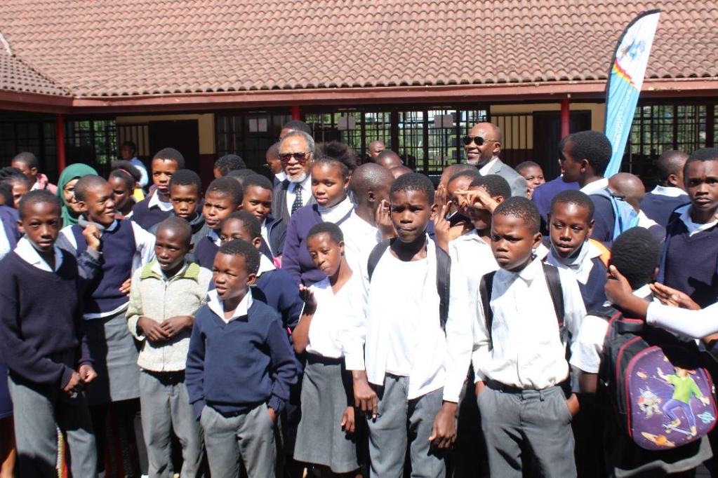 RC poses with children at the school